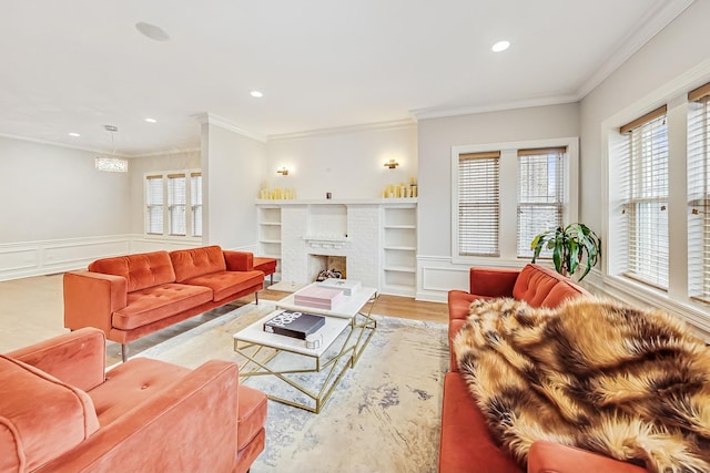 living room with ornamental molding, a brick fireplace, and light wood-type flooring