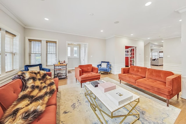 living room featuring crown molding and light wood-type flooring