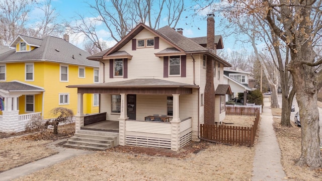 view of front of house with fence and a porch