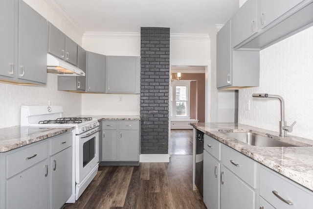 kitchen with a sink, white gas stove, under cabinet range hood, and gray cabinetry