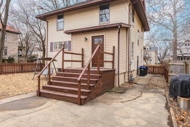 view of front of home featuring a patio area and fence