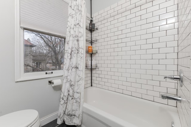 full bathroom with toilet and shower / bath combo with shower curtain