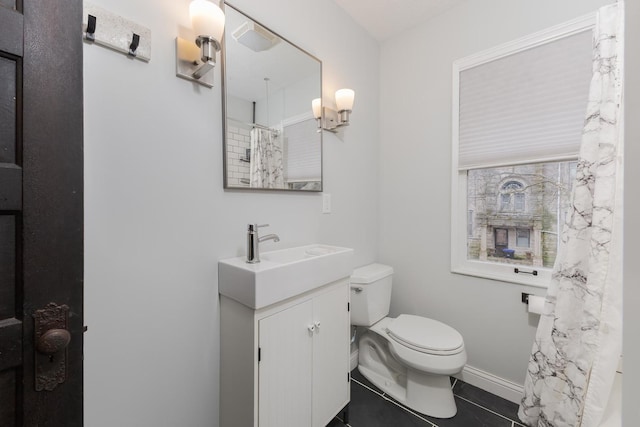 full bath featuring tile patterned flooring, baseboards, vanity, and toilet