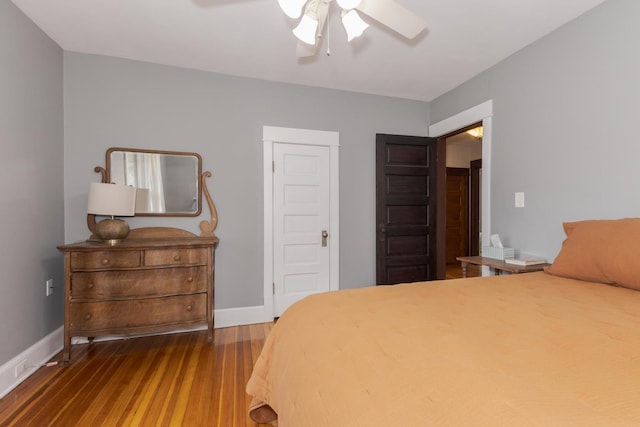 bedroom featuring ceiling fan, baseboards, and wood finished floors