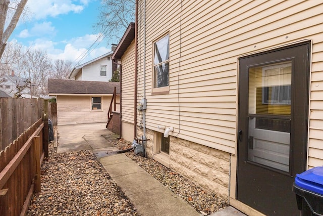 view of side of property with a patio area and fence