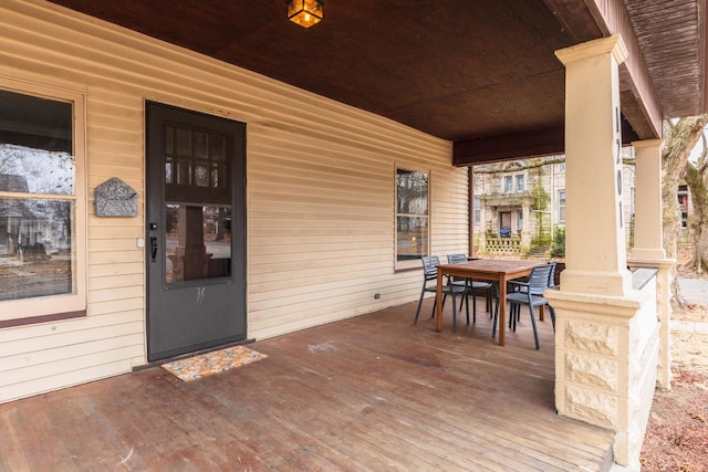 entrance to property with outdoor dining space and a porch