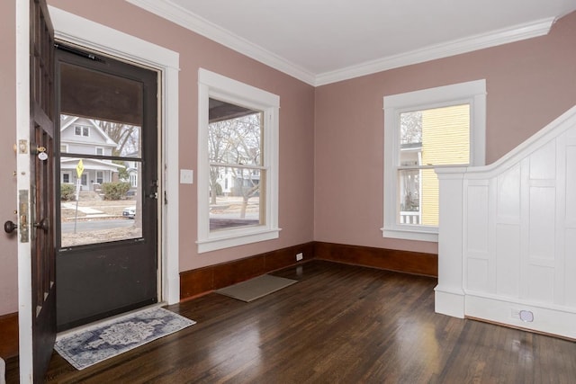 entrance foyer featuring dark wood-type flooring, crown molding, plenty of natural light, and baseboards