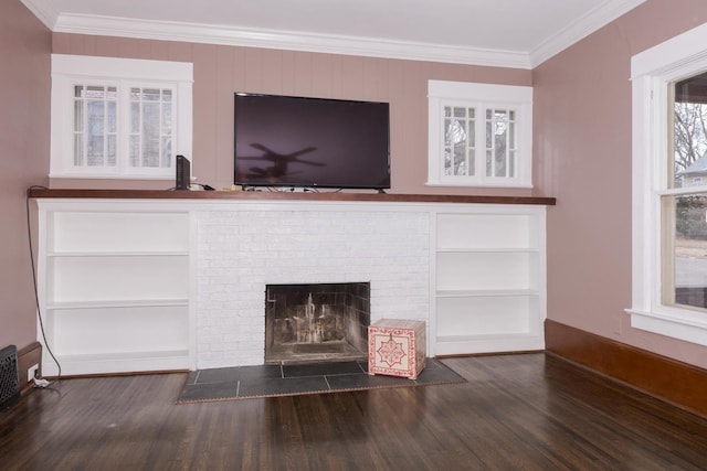 details with ornamental molding, a brick fireplace, baseboards, and wood finished floors