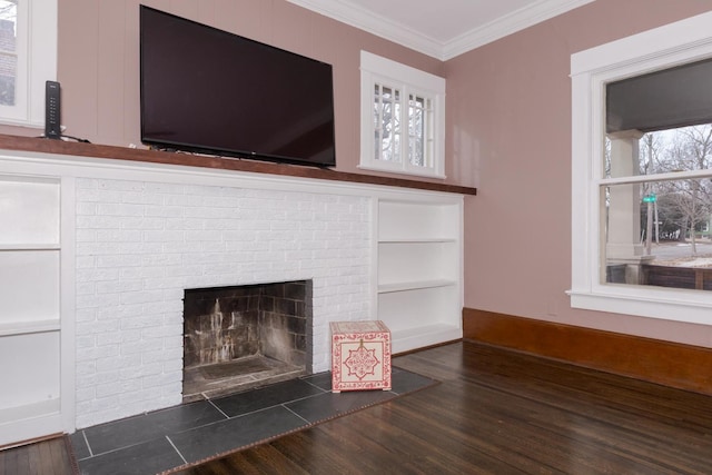 details featuring wood finished floors, baseboards, built in features, ornamental molding, and a brick fireplace