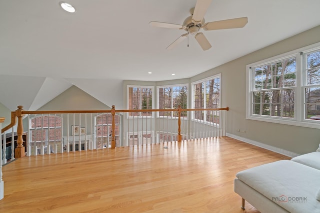 sitting room with a wealth of natural light, a ceiling fan, wood finished floors, and baseboards