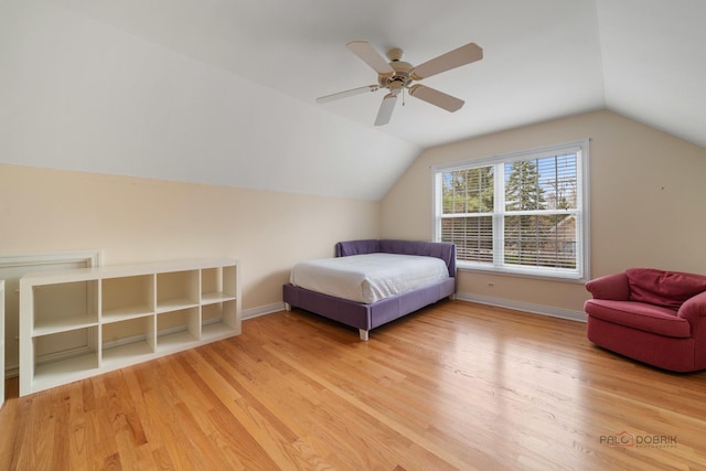 bedroom featuring ceiling fan, lofted ceiling, baseboards, and light wood-type flooring