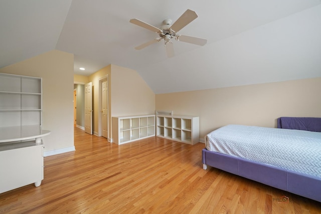 bedroom featuring vaulted ceiling, light wood finished floors, and baseboards