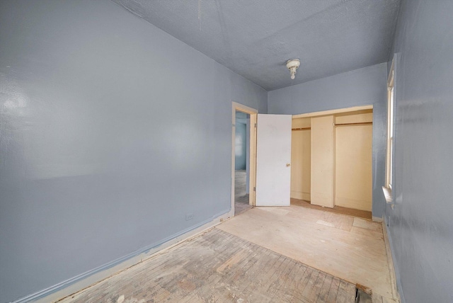 unfurnished bedroom with a closet and a textured ceiling