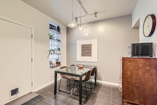 dining area featuring track lighting