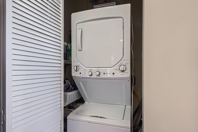 laundry room with stacked washer / dryer