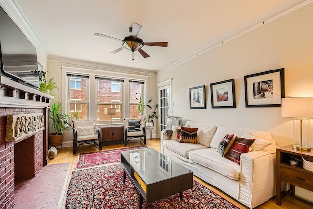 living room featuring hardwood / wood-style flooring, ornamental molding, and ceiling fan