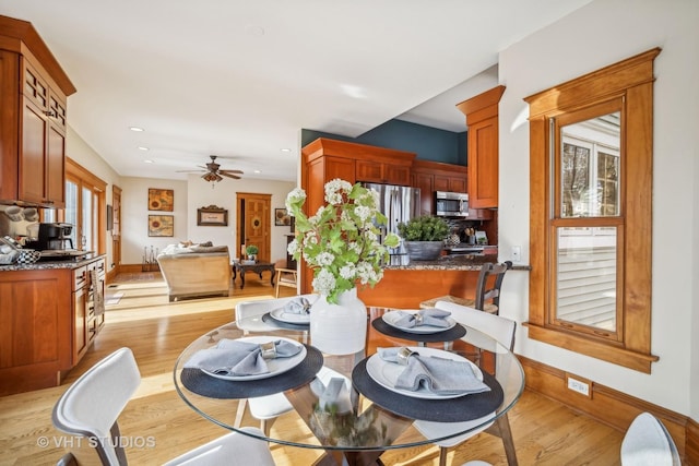 dining area featuring light hardwood / wood-style flooring and ceiling fan