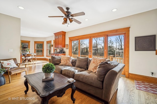 living room featuring light hardwood / wood-style flooring, french doors, and ceiling fan