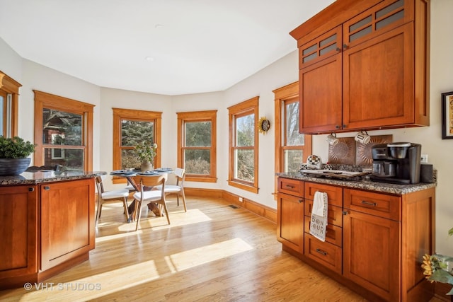 kitchen featuring dark stone counters and light wood-type flooring