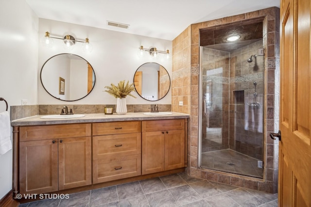 bathroom featuring vanity and an enclosed shower