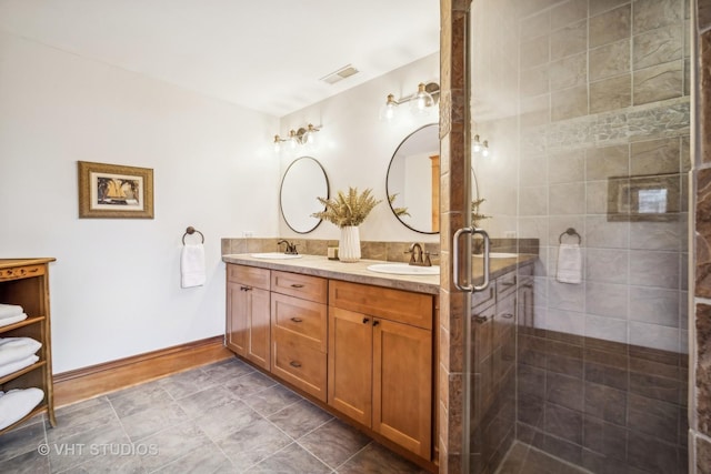 bathroom featuring vanity and a shower with shower door