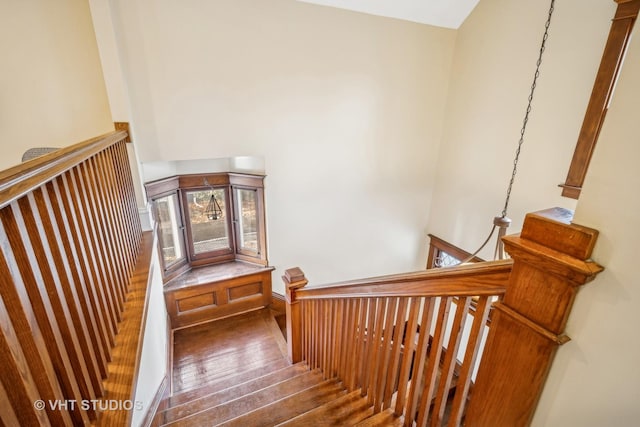 stairs with hardwood / wood-style flooring