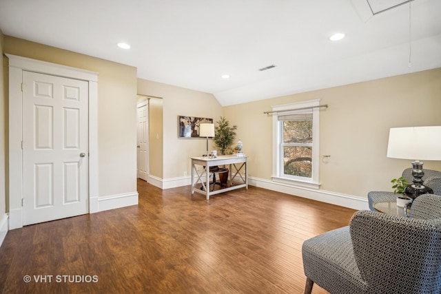 living area featuring hardwood / wood-style flooring and vaulted ceiling