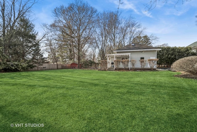 view of yard featuring a wooden deck and a pergola