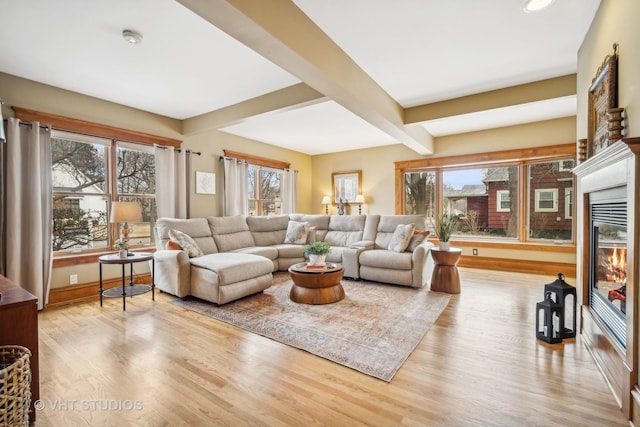 living room with beam ceiling and light hardwood / wood-style flooring