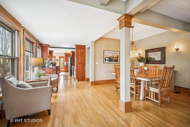 interior space featuring light hardwood / wood-style flooring and ornate columns