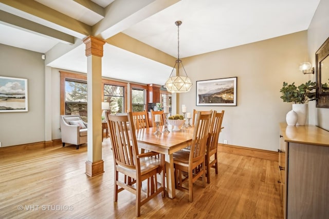 dining room featuring beam ceiling, light hardwood / wood-style floors, and decorative columns