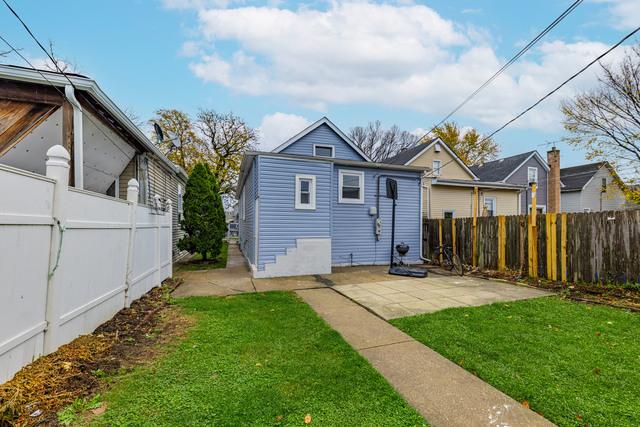 back of house with a patio and a yard