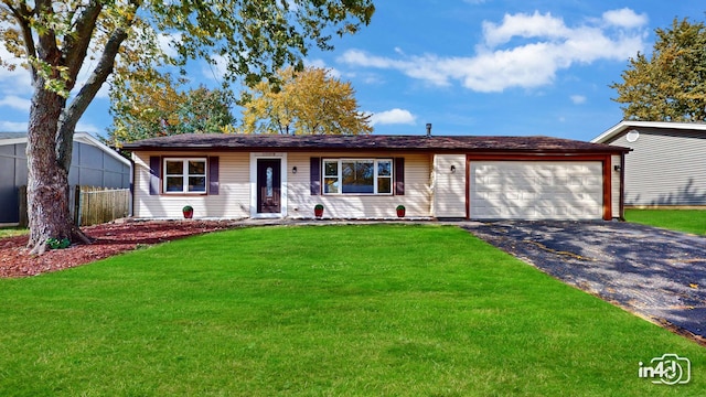 ranch-style house with a garage and a front lawn