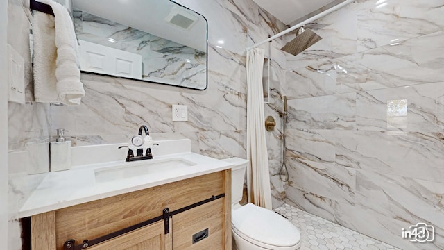 bathroom with vanity, tile walls, toilet, and walk in shower