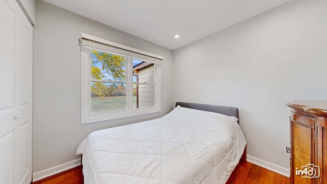 bedroom with dark wood-type flooring