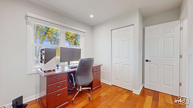 home office with light hardwood / wood-style floors