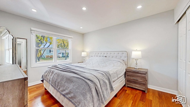 bedroom with hardwood / wood-style flooring and a closet