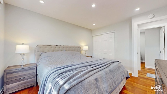 bedroom featuring hardwood / wood-style floors and a closet