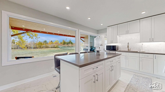 kitchen featuring sink, a wealth of natural light, and white cabinets