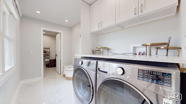 washroom featuring cabinets and washer and dryer