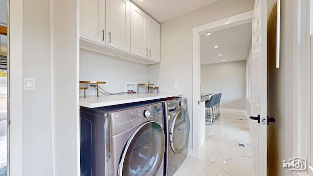 laundry area with cabinets and separate washer and dryer