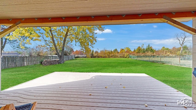 wooden terrace featuring a lawn