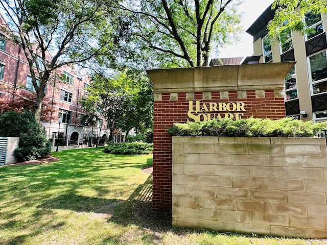 community / neighborhood sign with a lawn