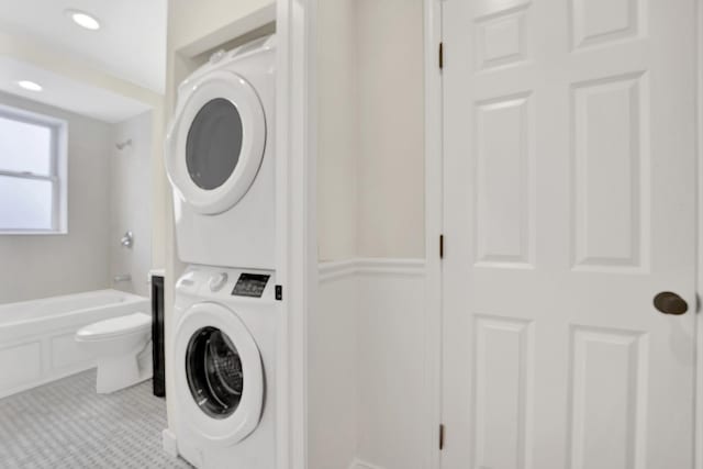 washroom featuring stacked washer and dryer