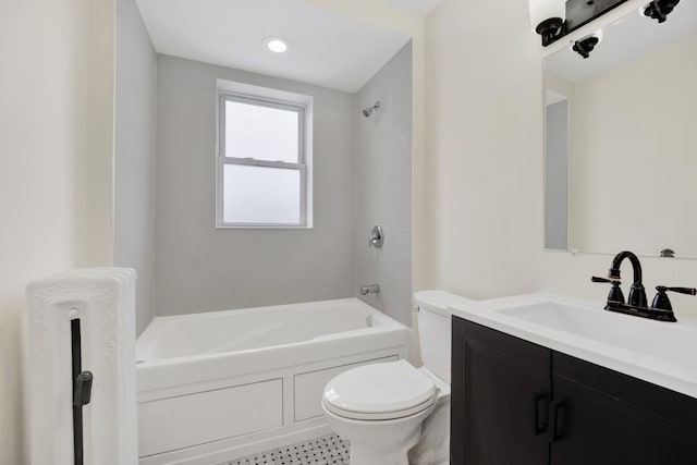 full bathroom with tiled shower / bath, vanity, and toilet