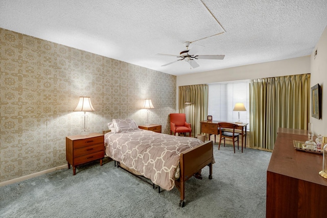 carpeted bedroom with ceiling fan and a textured ceiling