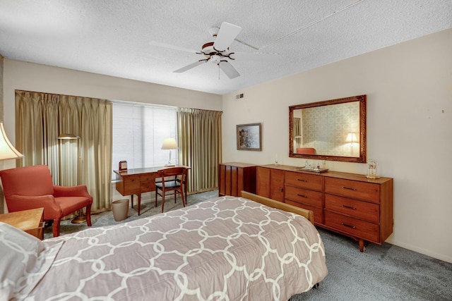 bedroom with ceiling fan, light carpet, and a textured ceiling