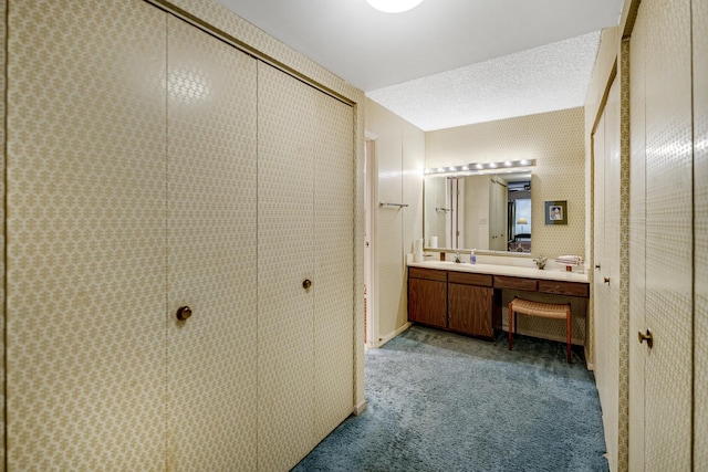 bathroom with vanity and a textured ceiling