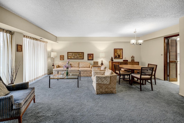 living room featuring carpet, a textured ceiling, and a chandelier