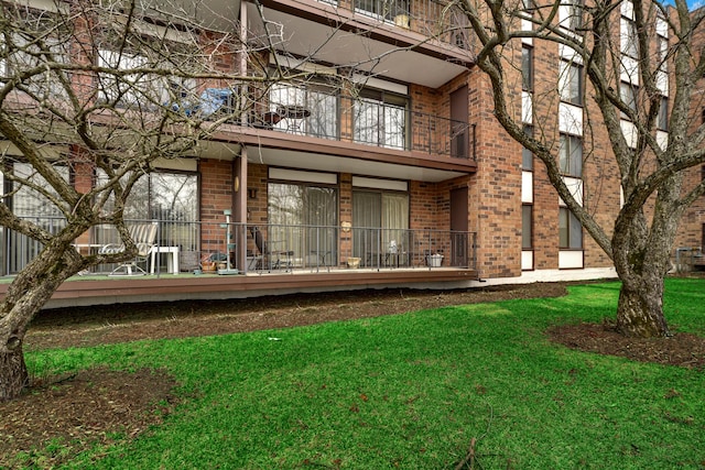 rear view of property featuring a lawn